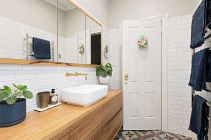 Above counter vanity basin with custom made brass wall mounted tapware