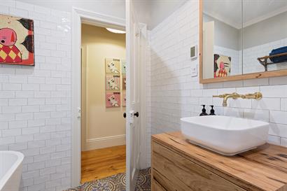 Above counter vanity basin with custom made brass wall mounted tapware