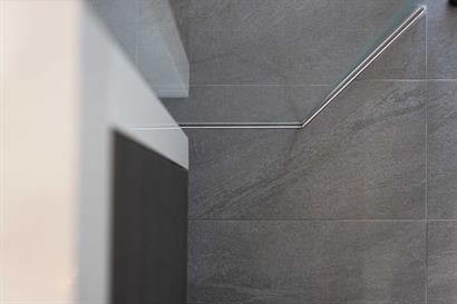 Large format rectangular bathroom floor tiles in grey with marble effect