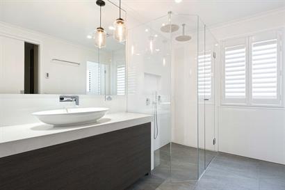 Light airy bathroom with freestanding basin and large frameless shower