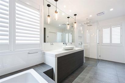Large contemporary bathroom filled with natural light and warm, neutral tones