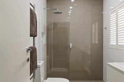 Large frameless shower with overhead rose 