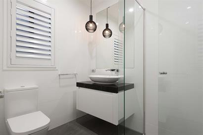 Compact ensuite bathroom with frameless shower and small floating bathroom cabinet