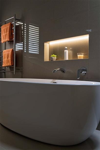 Freestanding bath with double towel rails and feature wall inset