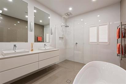 Frameless corner shower and twin basins in white gloss floating cabinets