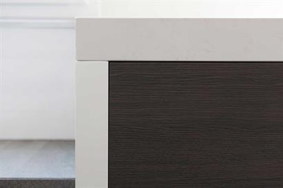 Gloss white bathroom cabinet with off-white stone benchtop and timber grain drawers