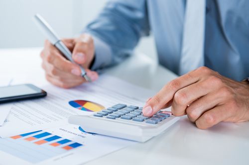 man sitting at desk working on financials