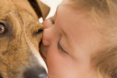 baby kisses dog