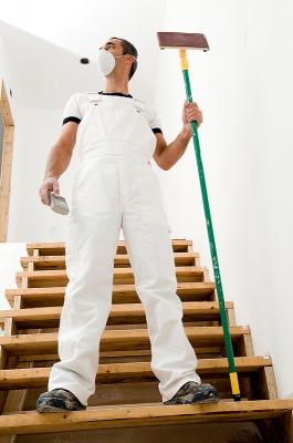 construction worker with pole sander