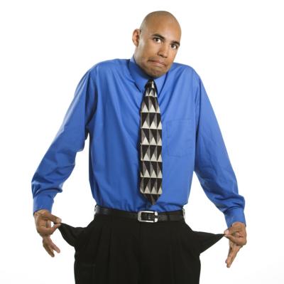 man in suit pulls out empty pockets and shrugs
