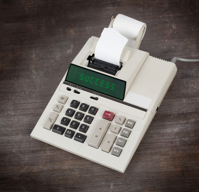 old calculator with word success on it