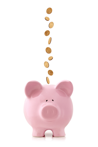 pennies falling into a piggy bank