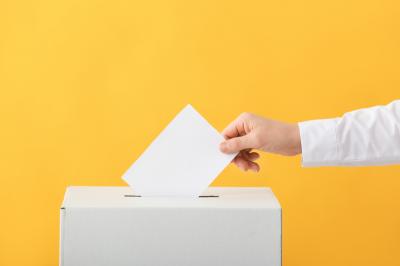 voting woman near ballot box