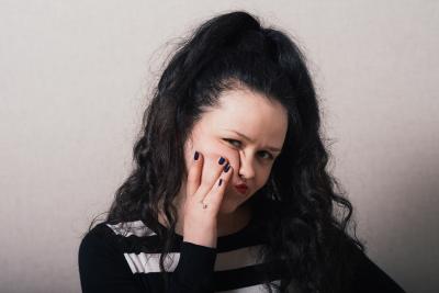 woman thinking with a gray background