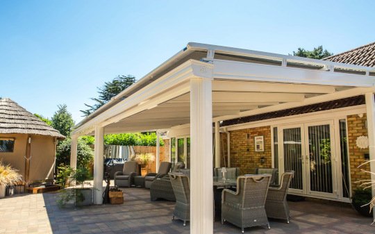 Cream veranda with a roof blind over a patio dining set