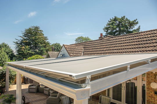 White retractable roof blind over a veranda