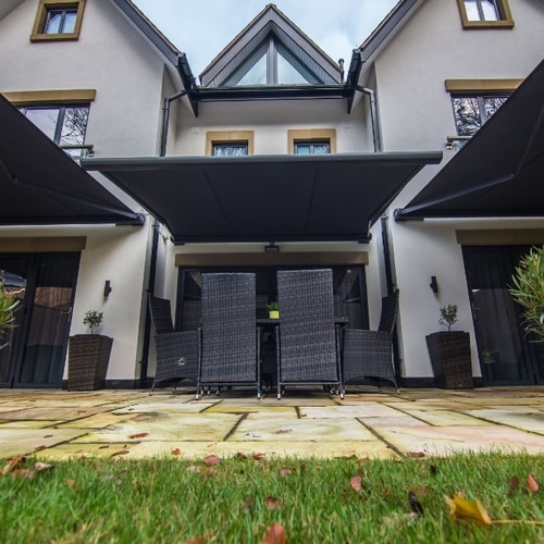Black awnings extended over two townhouse patios