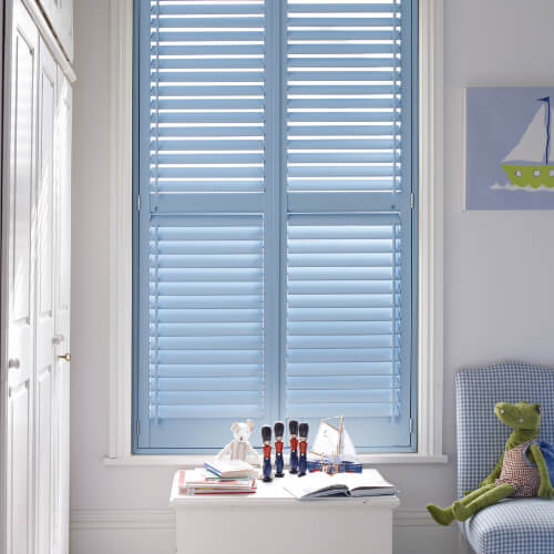 Pale blue plantation shutters in a child's bedroom