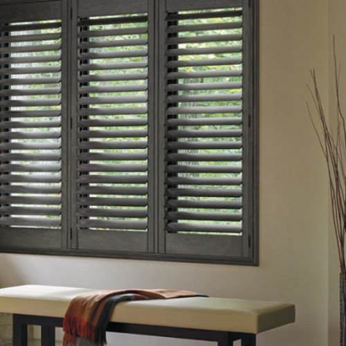 Charcoal plantation shutters above a hallway bench