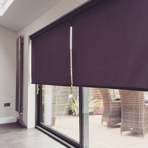 Aubergine blackout roller blind over conservatory patio doors