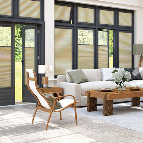 Cream Perfect Fit pleated blinds in grey UPVC frames