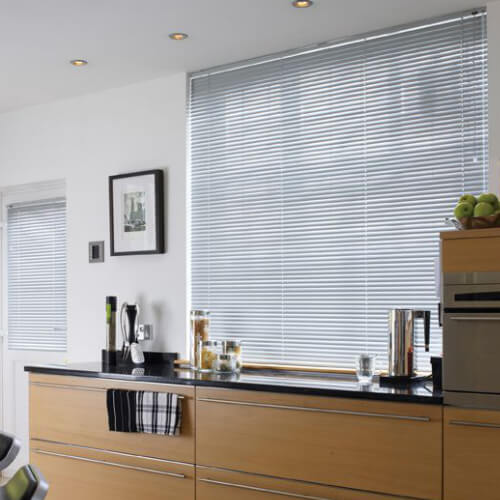 Grey wood Venetian blind above a kitchen worktop