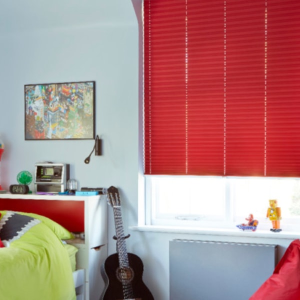 Red pleated blind in a child's bedroom
