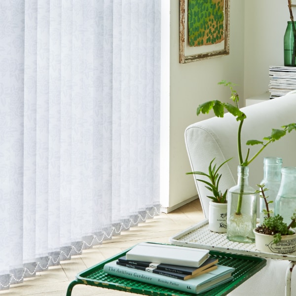 White vertical blinds across a patio window