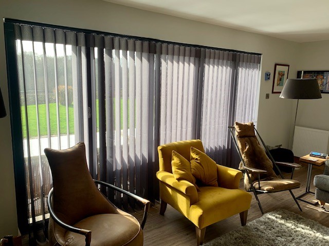 Charcoal Allusion sheer vanes across a bi-fold door wall