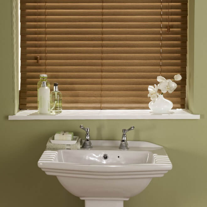 Oak effect faux wood Venetian blind above a bathroom basin