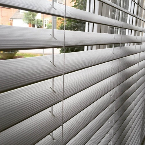 Close up of grey faux wood Venetian slats