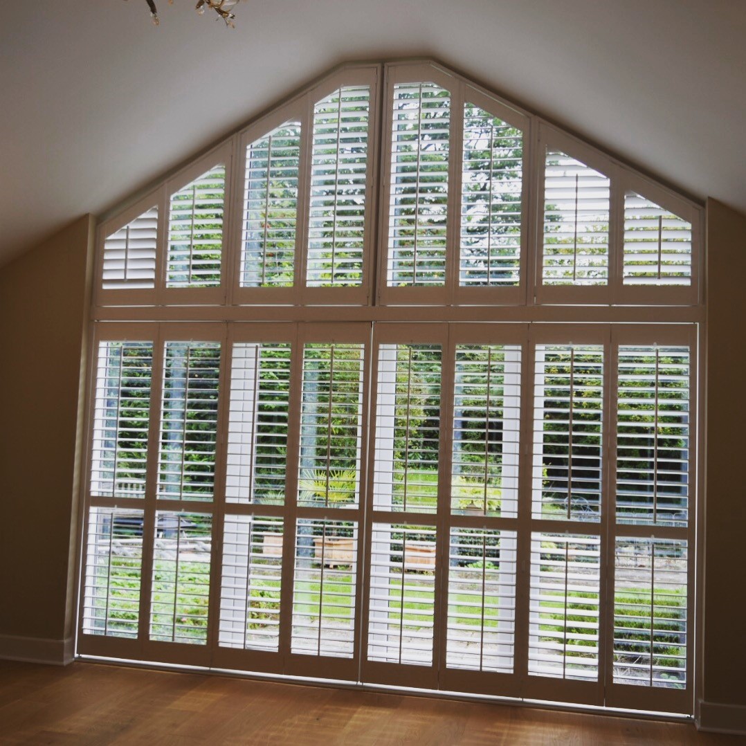 White shutters across a full height gable window