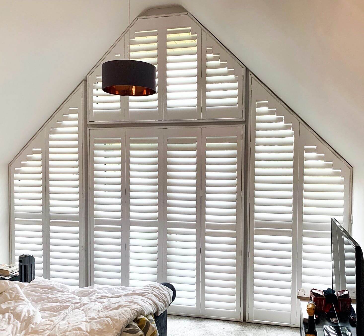 White shutters fitted to an apex bedroom window