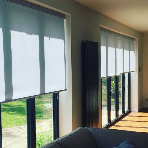 White motorised roller blinds across patio doors