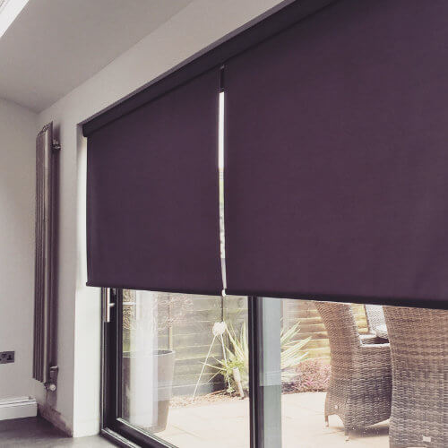 Aubergine motorised roller blind over patio doors