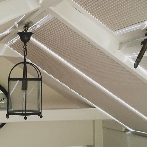 Taupe pleated blinds on a conservatory roof