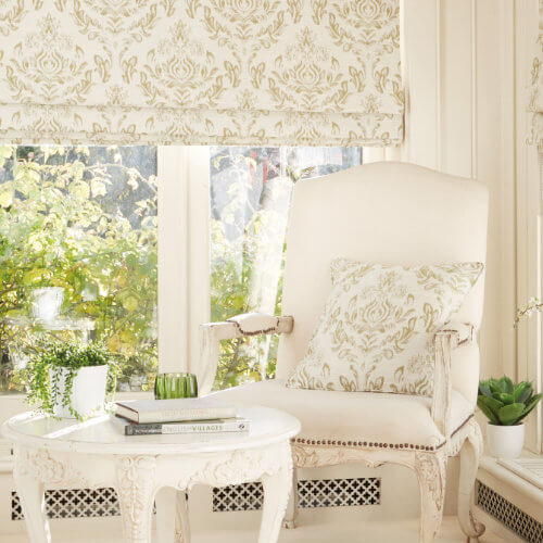 Cream damask roman blind in a sitting room