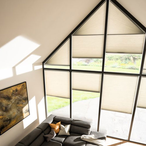 Cream Duette blinds on an apex living room window