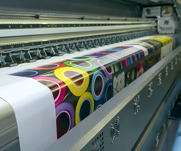 large format industrial inkjet printer printing a colorful vinyl sign