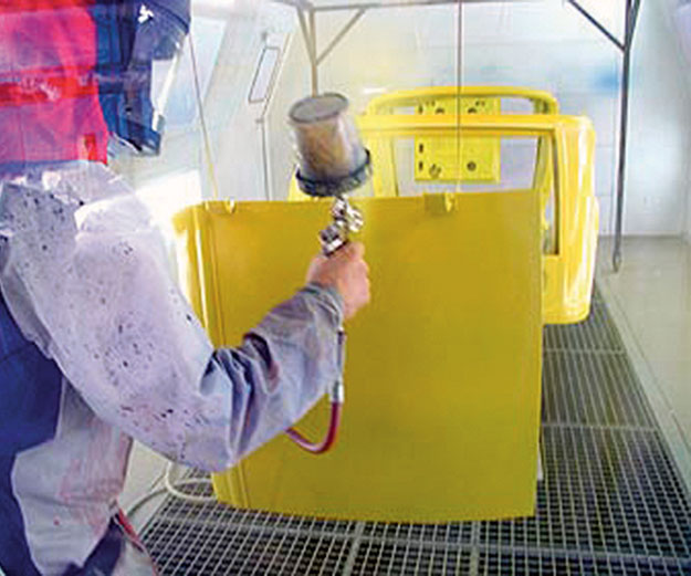 spray painting parts on an assembly line