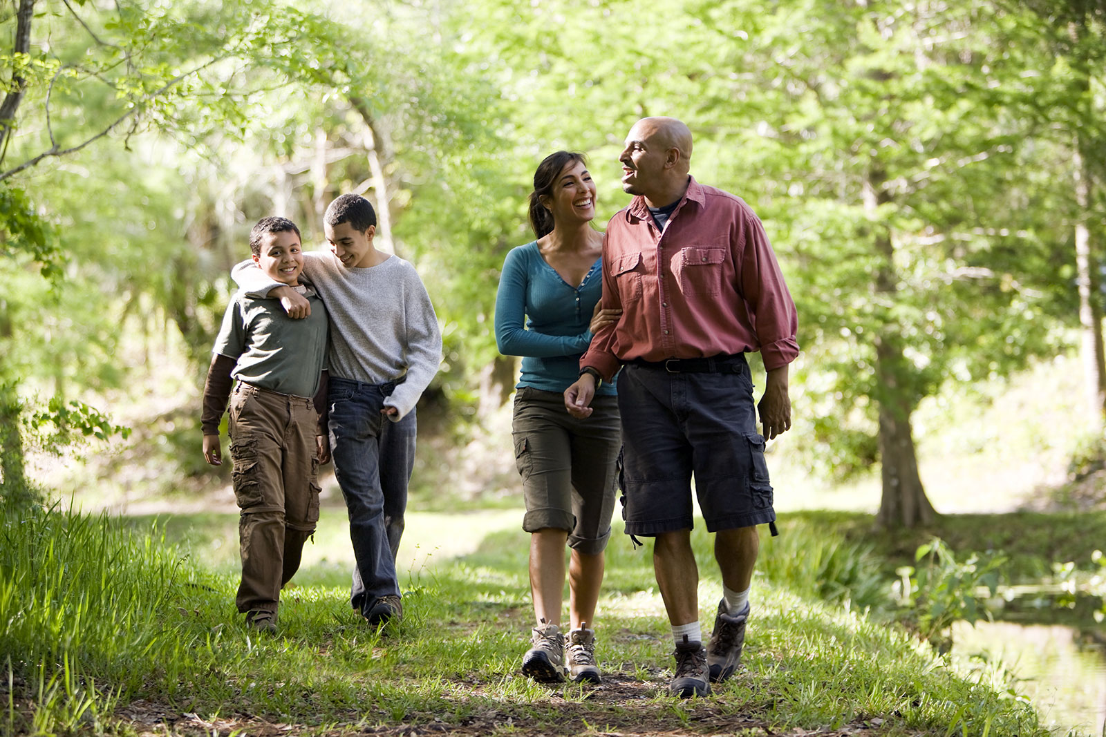 Hispanic family with two teen boys on a hike in the park
