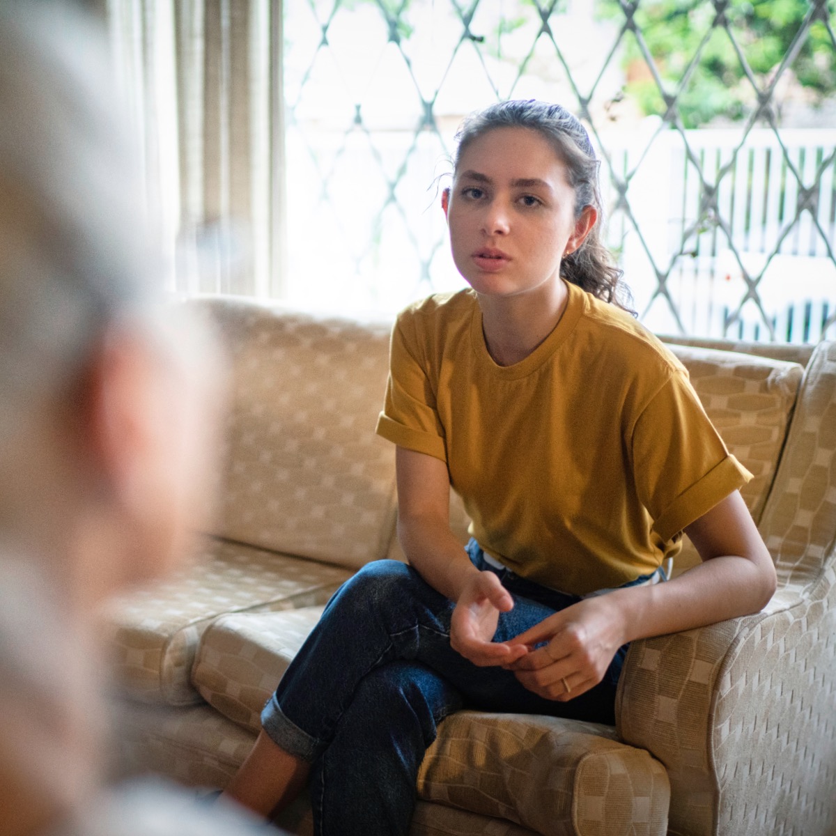 Young woman in therapy with a psychotherapist at home