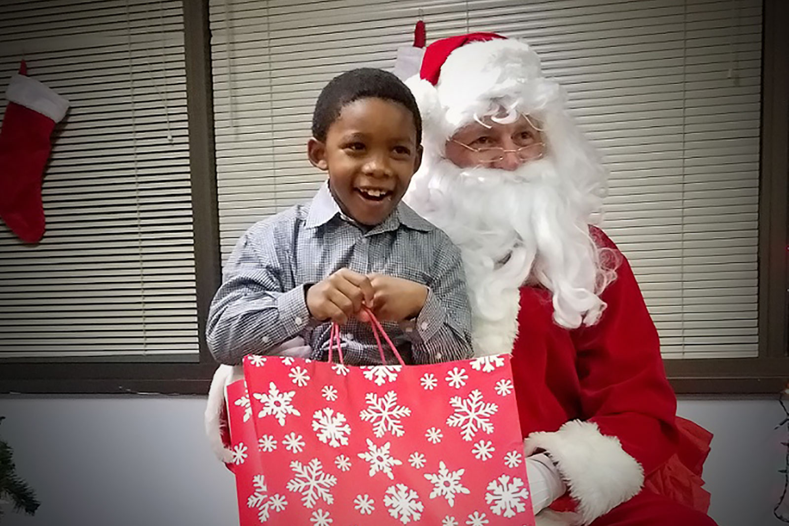 a very happy little boy meeting Santa Claus