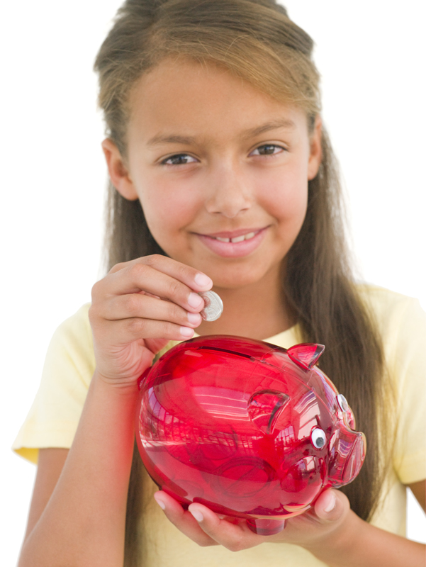 girl places money in piggybank