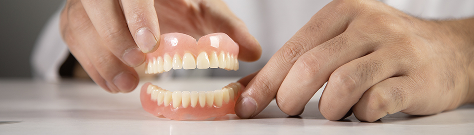 Close up of dentures being displayed on white table