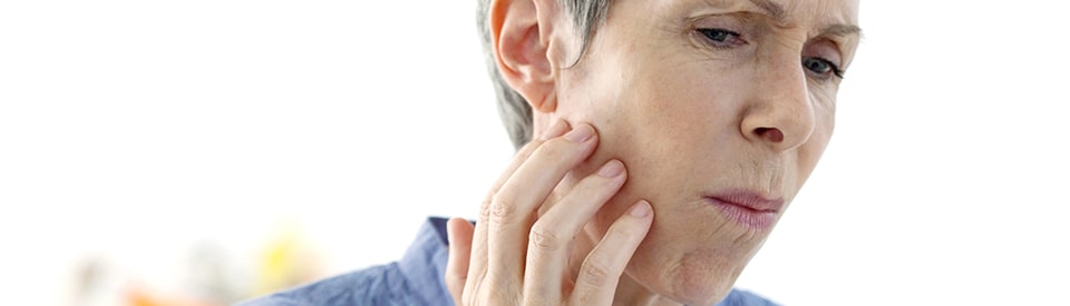 Woman experiencing jaw pain