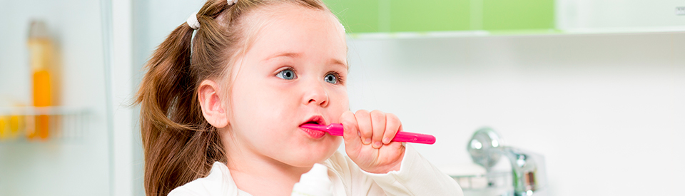 Little girl with pink toothbrush 
