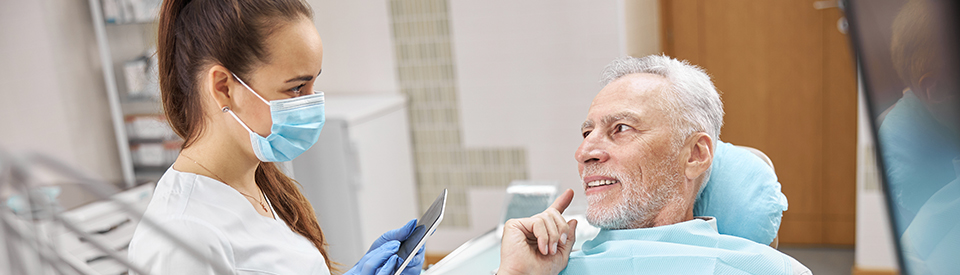 Older Man Speaking to Dentist