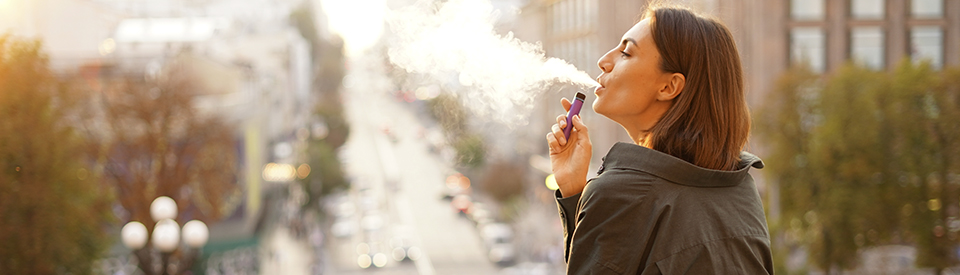 woman smoking e-ciggarette or vaping