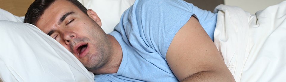 man sleeping with his mouth opening snoring